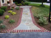 A walkway with brick and stone is shown.