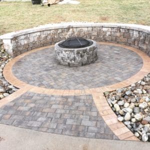 A fire pit sitting in the middle of a patio.