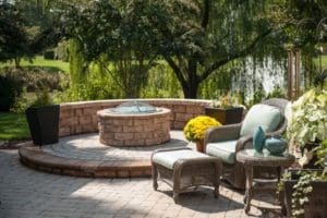 A patio with furniture and a fire pit.